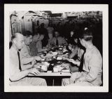 USS Saratoga birthday party, men eating at a table 